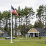Cabin in the Woods image of exterior cabins and flag pole